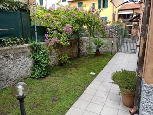 un giardino fiorito con recinzione e marciapiede di La Chiocciola a La Spezia