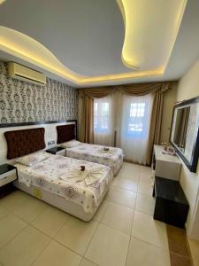 A bed or beds in a room at Yalcin Hotel & Villas