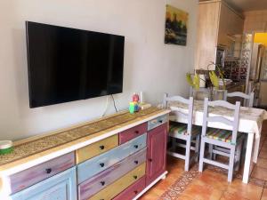 a flat screen tv on a wall above a dresser at Sea View House in Gran Alacant