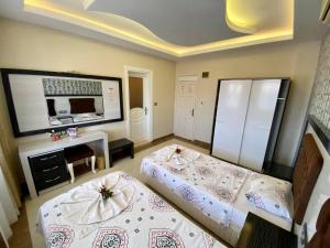 A bed or beds in a room at Yalcin Hotel & Villas