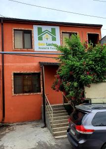 an orange building with a staircase leading to a door at Bee Lucky Hostel and Tours in Yerevan