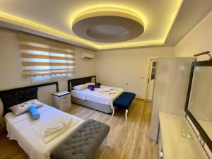 A bed or beds in a room at Yalcin Hotel & Villas
