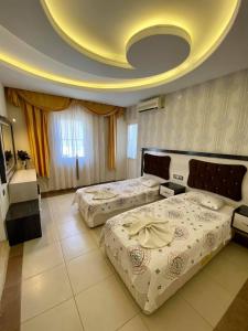 A bed or beds in a room at Yalcin Hotel & Villas