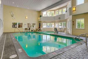 a large swimming pool with blue water in a building at Comfort Inn Traverse City in Traverse City