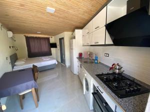 a small kitchen with a bed in a room at Beyoglu Pansiyon in Patara