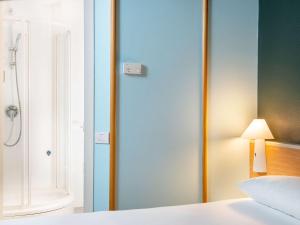 Postel nebo postele na pokoji v ubytování Hotel Ibis Firenze Prato Est