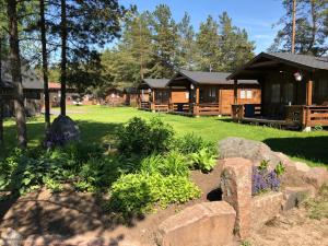 a log cabin with a garden in front of it at Viking Motel in Hanko