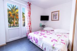 a bedroom with a bed and a window at Petra Apartment in Rab