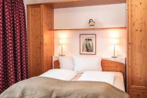Ένα ή περισσότερα κρεβάτια σε δωμάτιο στο Prà de Metz Apartments