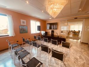 a room with chairs and a table and a chandelier at Green Park Hotel in Peschiera del Garda