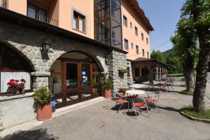 a group of tables and chairs outside of a building at Albergo Bucaneve in Pievepelago