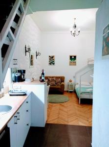 a kitchen with a sink and a living room at Old Town Studio With Picture Perfect Terrace ! in Tbilisi City