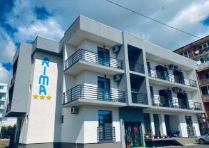 a white building with a sign on the side of it at RIMA Del Mar in Eforie Nord