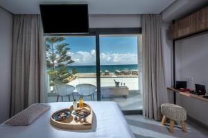 a hotel room with a view of the ocean at Enorme Teatro Beach - Adults Only in Amoudara Herakliou