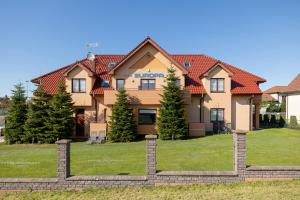 a large house with a fence in front of it at Holiday House Europa in Rewal