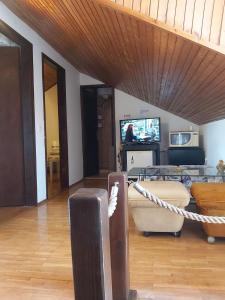 a living room with a wooden ceiling with a rope at Rooms Megi in Dubrovnik