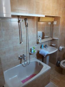 a bathroom with a bath tub and a sink at Rooms Megi in Dubrovnik
