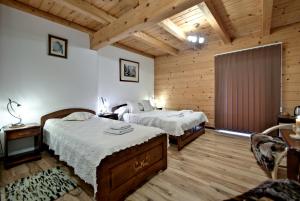 Postel nebo postele na pokoji v ubytování Magnat Inn Sauna & Relax