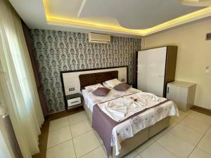 A bed or beds in a room at Yalcin Hotel & Villas