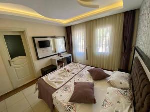 A bed or beds in a room at Yalcin Hotel & Villas