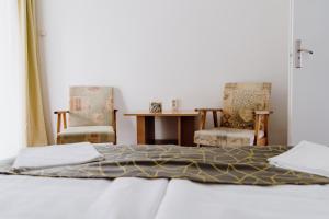 Postel nebo postele na pokoji v ubytování Nyírfa Apartman
