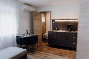 a kitchen with a sink and a counter top at Nyírfa Apartman in Vonyarcvashegy