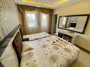 A bed or beds in a room at Yalcin Hotel & Villas