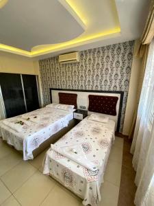 A bed or beds in a room at Yalcin Hotel & Villas