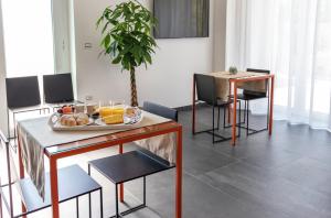 a living room with a table with a plate of food on it at Corte Lissa in Termoli