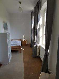 a bedroom with black curtains and a bed in a room at Gutshaus Thorstorf FeWo Wismar in Thorstorf