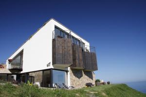 a house on top of a hill with the ocean at Agroturismo Haitzalde B&B - Adults Only in Mutriku