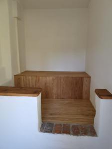 a room with two wooden shelves in a room at Gutshaus Thorstorf FeWo Wismar in Thorstorf