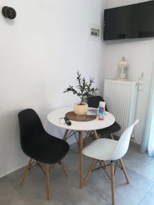 a table and chairs in a living room at Aiolos Blu Luxury Apartments in Nea Roda