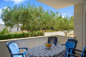 a table with a bowl of fruit on a balcony at Golden Cape Apartments in Bol