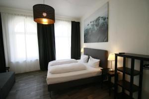 a bedroom with two beds and a large window at Hotel Bee Fang in Hamburg