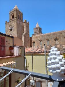 a view from a balcony of a building with a tower at Balcone delle mura in Cefalù