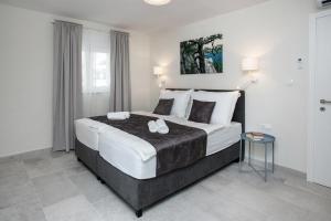 a bedroom with a large bed and a table at Villa Fig in Split