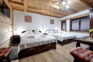 Postel nebo postele na pokoji v ubytování Magnat Inn Sauna & Relax
