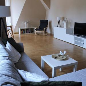 a living room with a couch and a table at Villa Schlossblick in Wernigerode