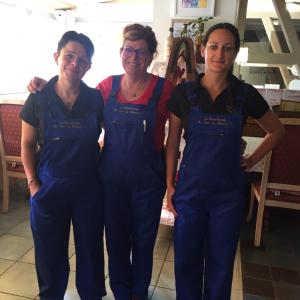 three women in blue overalls posing for a picture at Hotel Restaurant La Petite Auberge Alsace in Le Hohwald