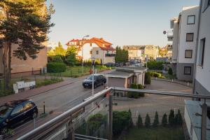 a view of a street with a car on the road at Apartament Morski Piasek in Władysławowo