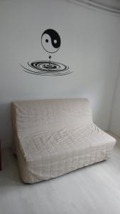 a bed in a room with a face on the wall at Le Loubens in Arette