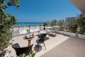 einen Balkon mit Tisch und Stühlen sowie Strand in der Unterkunft Hotel Riviera in San Vito lo Capo