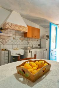 a box of oranges sitting on a table in a kitchen at Casa Caterina in Tertenìa