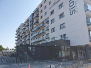 an apartment building with a sign in front of it at Cozy Apartment Gdynia in Gdynia