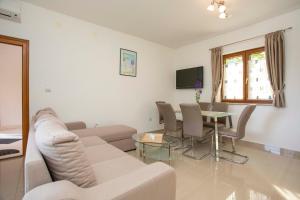 a living room with a couch and a table at Apartmani Marica in Plomin