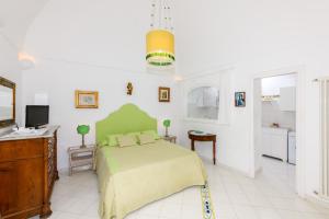 a bedroom with a bed and a desk and a television at Proprietà Antonio 3 unità indipendenti in Positano