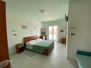 a bedroom with a bed and a window in it at Hotel Capri in Bellaria-Igea Marina +57 photos