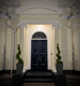 a doorway leading to a room with a large window at Magherabuoy House Hotel in Portrush
