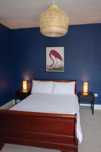 A bed or beds in a room at Rooms At The Rosebery 